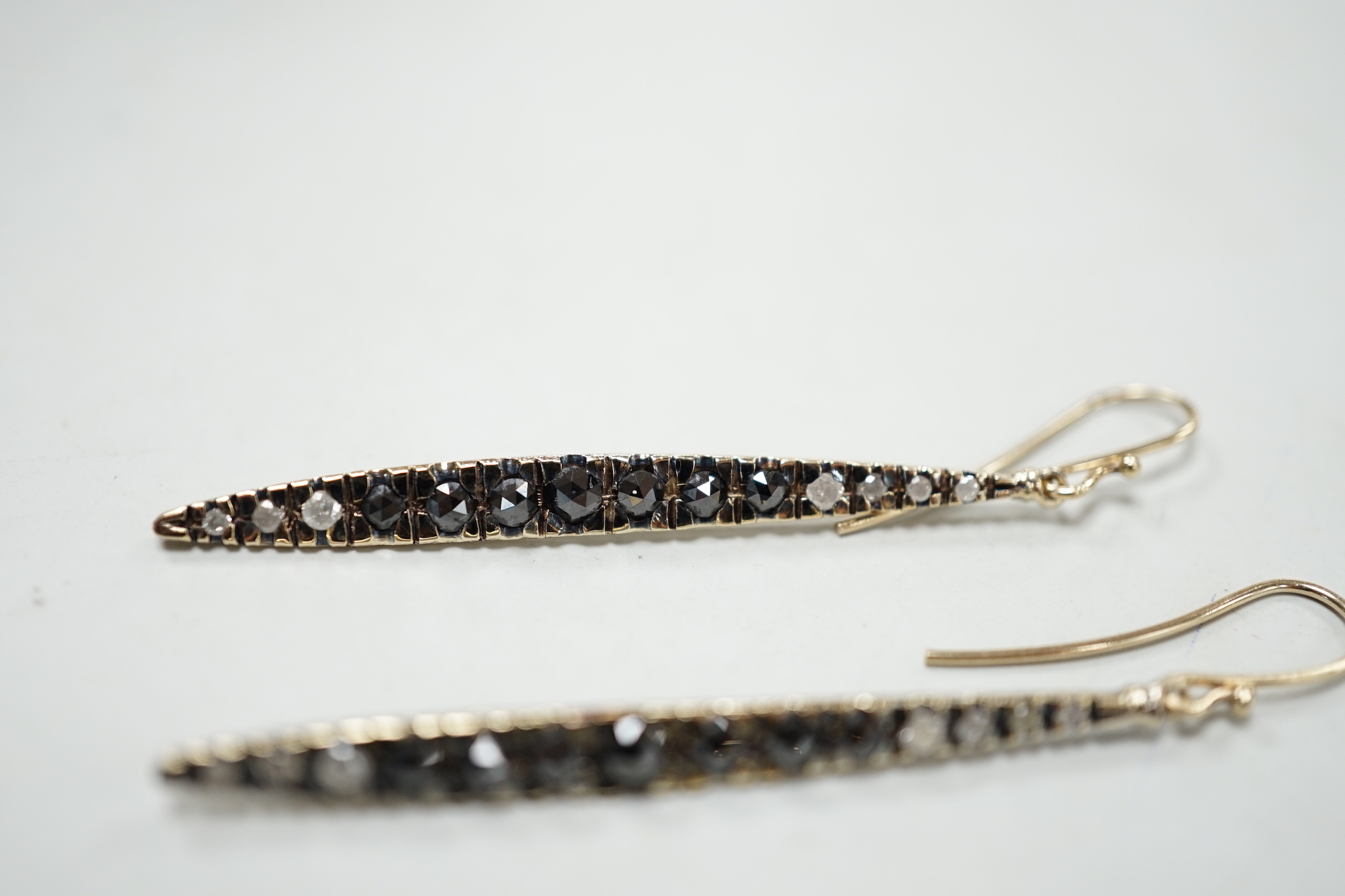 A modern pair of 14k yellow metal and two row diamond chip set half hoop earrings, 14mm, gross weight 4.6 grams, together with a modern pair of 18ct gold and two colour diamond set line earrings, 47mm, gross weight 5.3 g